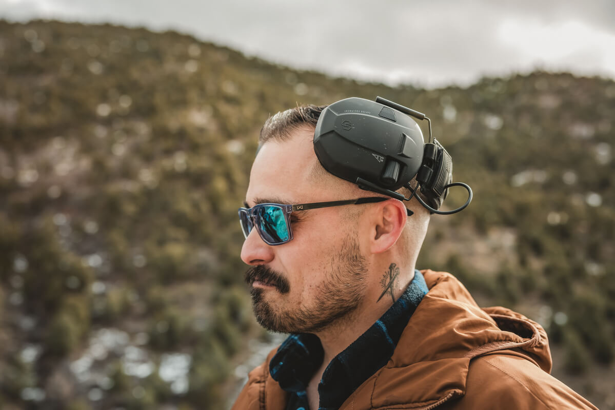 Man wearing the WX AXE Captivate Polarized Green Mirror Lenses with Gloss Crystal Grey Sunglasses